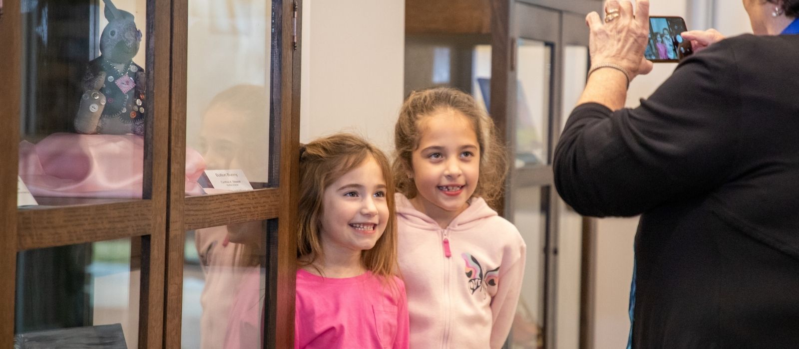 Girls pose by an art display for a photo